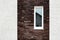 Facade stucco. Wall of house with self-made plastered facade and dark decorative torn brick.
