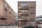 Facade of a three-story residential building with brown brick seen