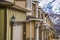 Facade of townhouses with close up view of garage doors flanked with wall lamps