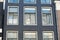 Facade of traditional Amsterdam houses. Windows detail.