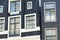 Facade of traditional Amsterdam houses. Windows detail.