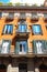 Facade of traditional colorful european italian apartment building in Rome , Italy.