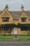 Facade of a traditional detached limestone house in Broadway, Cotswolds, UK