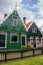 Facade of traditional dutch buildings in village. Old brick and wooden houses in Zaanse Schans, Netherlands.