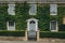 Facade of a traditional house in Broadway, Cotswolds, UK, covered with ivy
