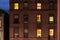 Facade of a typical brownstone apartment building at night, in Harlem, New York City, NY, USA