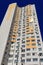 Facade of typical high rise apartment building with balcony and windows on blue sky background. Contemporary architecture.