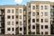 Facade typical middle storey residential building under a blue cloudy sky and footpath slope