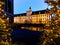 Facade of University of Wroclaw building reflecting in Odra river at afternoon with christmas