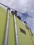 Facade with ventilation pipes under a cloudy Caribbean sky and suspended electrical wiring. Architecture and construction detail