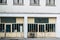 Facade of a warehouse with glass doors and old cart wheels