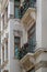 Facade of white building with narrow windows and elegant decorative balconies