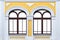 Facade of white yellow ancient building with two isolated arched windows mock up