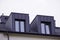 Facade of windows in attic or loft housing or office. Apartments under the roof in a modern house or cottage. Close-up