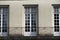 Facade with windows in an old tenement house in France, French architecture