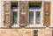 Facade with windows with stained glass and wooden shutters