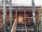 Facade of wooden summer cottage in the shade of trees.