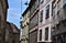 Facades of buildings, one of which at the bottom, richly decorated and a glimpse of blue sky in Graz.