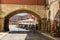 Facades of the colorful buildings and houses in the Alta Square in Badajoz seen from under the arch of the Peso (Spain