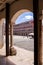 Facades of the colorful buildings and houses in the Alta Square in Badajoz seen from under an arch (Spain