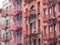 Facades of historic buildings in the Soho district of New York. The characteristic iron safety stairs on the facades