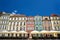 Facades of historic tenements houses and umbrellas of the restauranton the Old Market Square