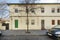 Facades of old low-rise residential houses with deciduous trees on a sunny winter day