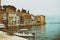 Facades with peeling plaster washed by the sea of the old town of Porec. Croatia and the boat in the foreground. Vintage toning