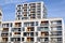 Facades of two modern white apartment buildings with balcony in contemporary residential district