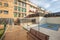 Facades of urban residential buildings with landscaped common areas and a pool covered with canvas to spend the winter with a clay