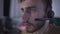 Face of absorbed nervous gamer in headset playing video games online. Side view portrait of addicted young Caucasian man
