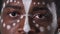 Face of an African American man with an ethnic white pattern. Black male seriously looking straight. Green screen