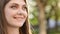 Face attractive brunette woman at sunset smiling beautiful around blue eyes. Stand outdoor relax. Happy relax. Close up