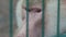 Face of baboon monkey close up behind bars papio cynocephalus