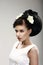 Face of Beautiful Brunette Bride Fashion Model. Elegant Hairdo with Vernal Flowers