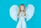 Face of beautiful little angel girl on color background. Looks like an angel. Angels little hands crossed for you