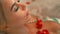 Face beautiful woman bathing in jacuzzi water with rose petals in spa. Portrait woman lying in jacuzzi tub in luxury spa