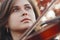 Face of beautiful woman with violin under her chin bottom view, romantic girl engaged in art, performance on autumn nature,