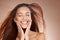 Face, beauty skincare and woman with eyes closed in studio on a brown background mockup. Hands, makeup cosmetics and