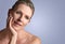 Face, beauty and space with mature woman in studio on gray background for aesthetic wellness. Skincare, relax and mock