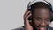 Face of black cheerful man in headphones.