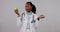 Face, black woman and doctor with apple, donut and options with decision on a white studio background. Portrait, happy