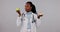 Face, black woman and doctor with apple, snack and options with nutrition on a white studio background. Portrait