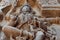 Face, breast of female Hindu god on old sculpture wall. Relief of 12th century Hoysaleshwara temple in Halebidu, India