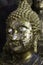 Face Buddha statue with gold plate attached to many