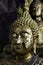 Face Buddha statue with gold plate attached to many