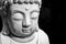 Face of Buddha statue white isolated on black background. Founder of Buddhism. Black and white photo, close up