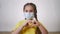 face child protective mask shows a gesture heart. stay home coronavirus quarantine kid dream concept. little girl