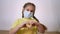 face child protective mask shows a gesture heart. stay home coronavirus quarantine kid dream concept. little girl