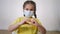 face child protective mask shows a gesture heart. stay home coronavirus quarantine kid dream concept. little protection